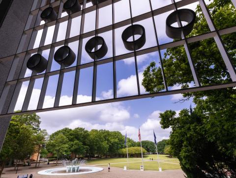 a photo of kaufman mall taken through the ornate window decorations of the webb center